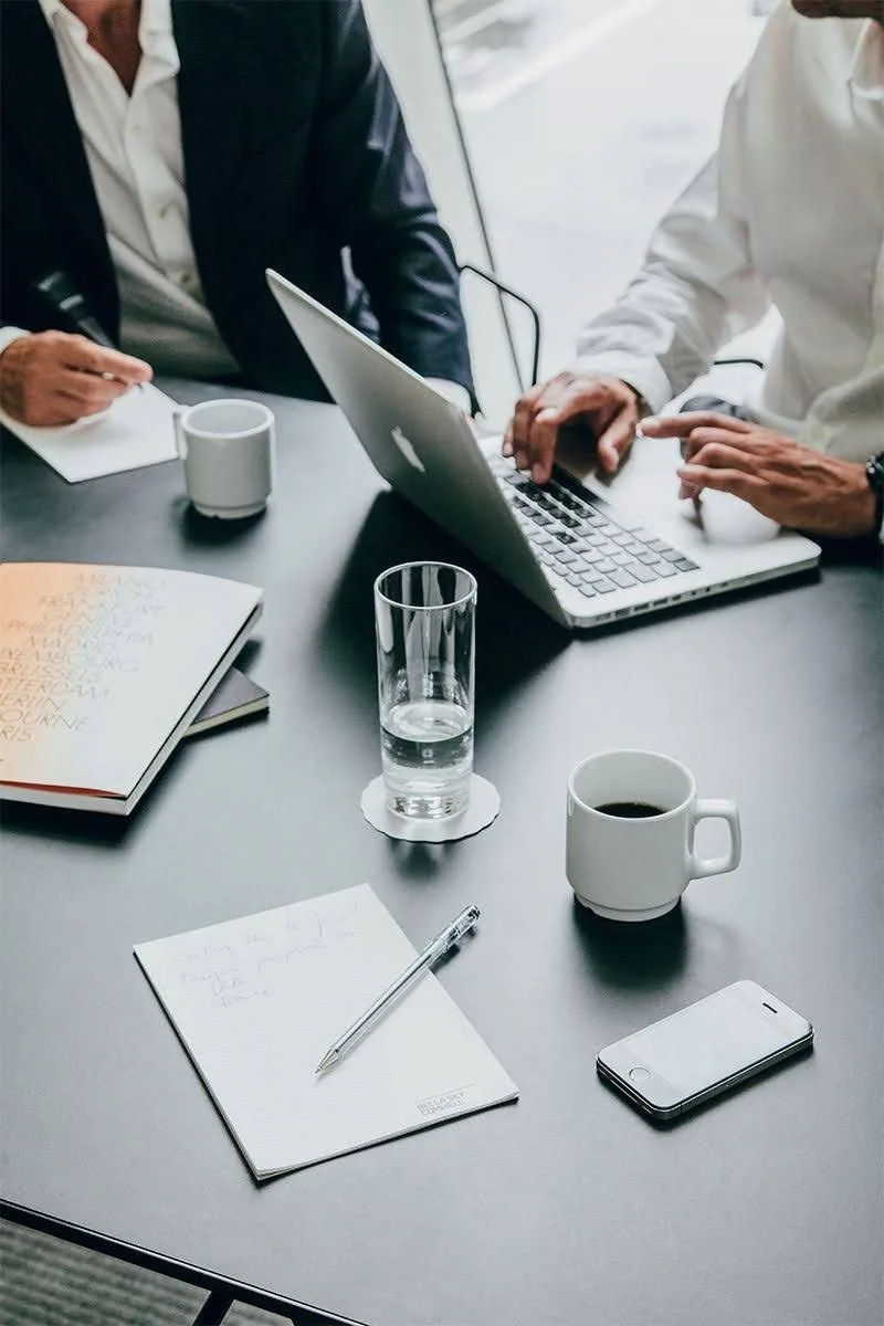 Mesa de trabajo con documentos, vasos y una tableta
